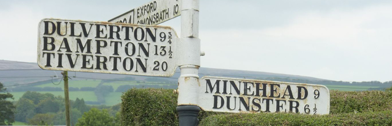 Signpost in centre of Wheddon Cross.